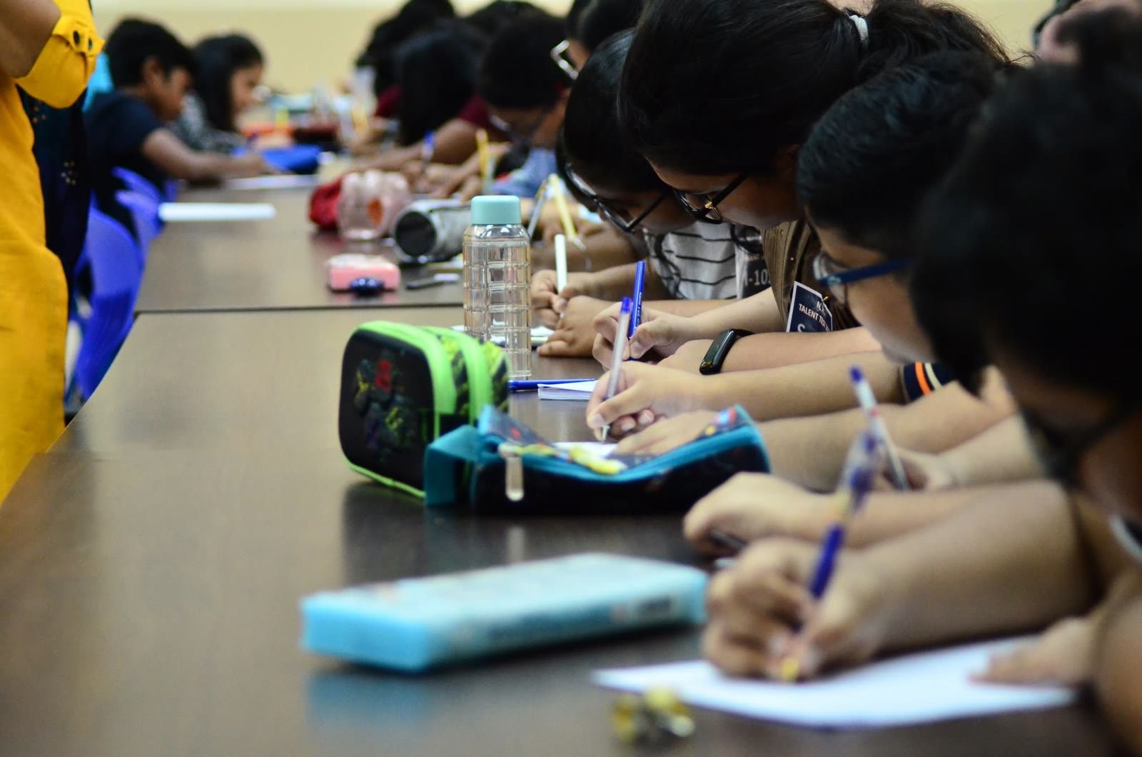 Children writing their Sunday School exams